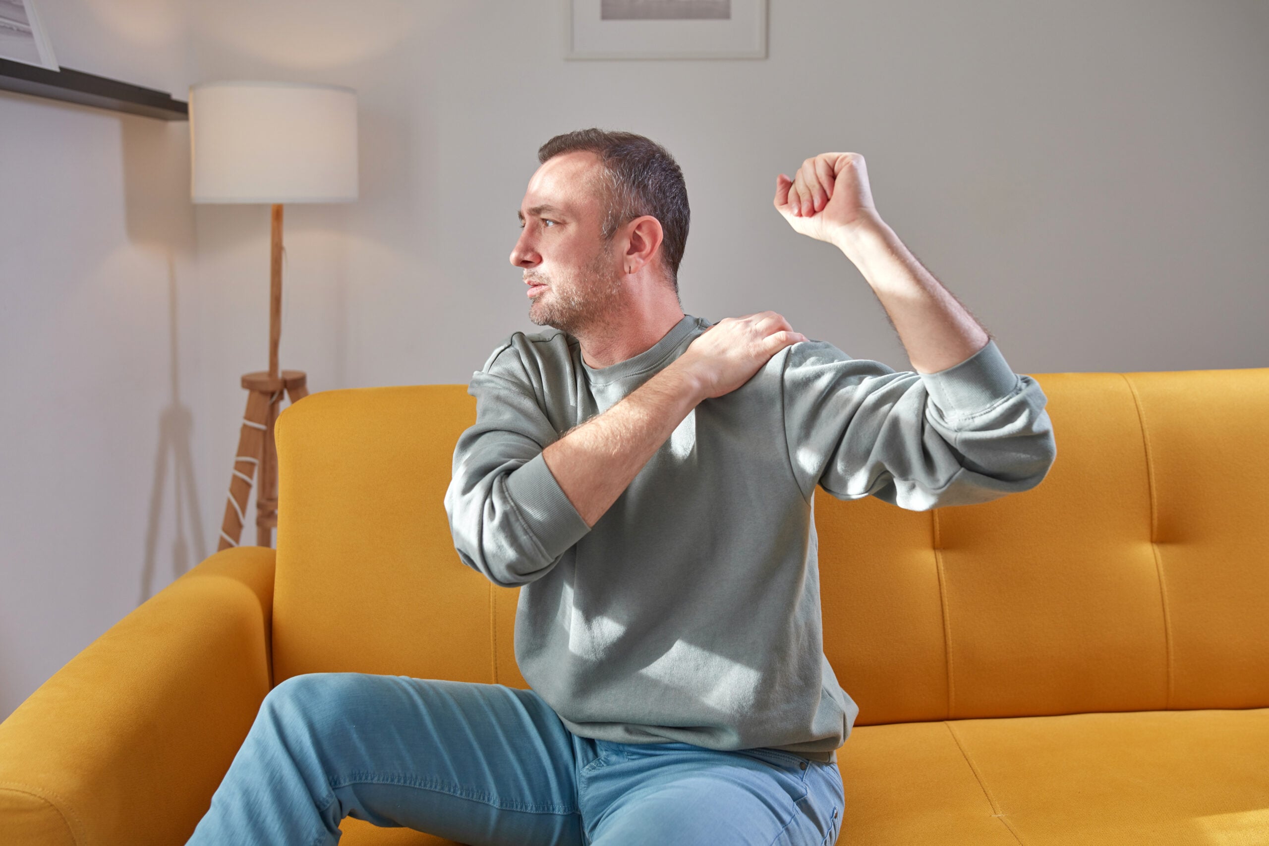 Man stretching his shoulder during mobility exercise